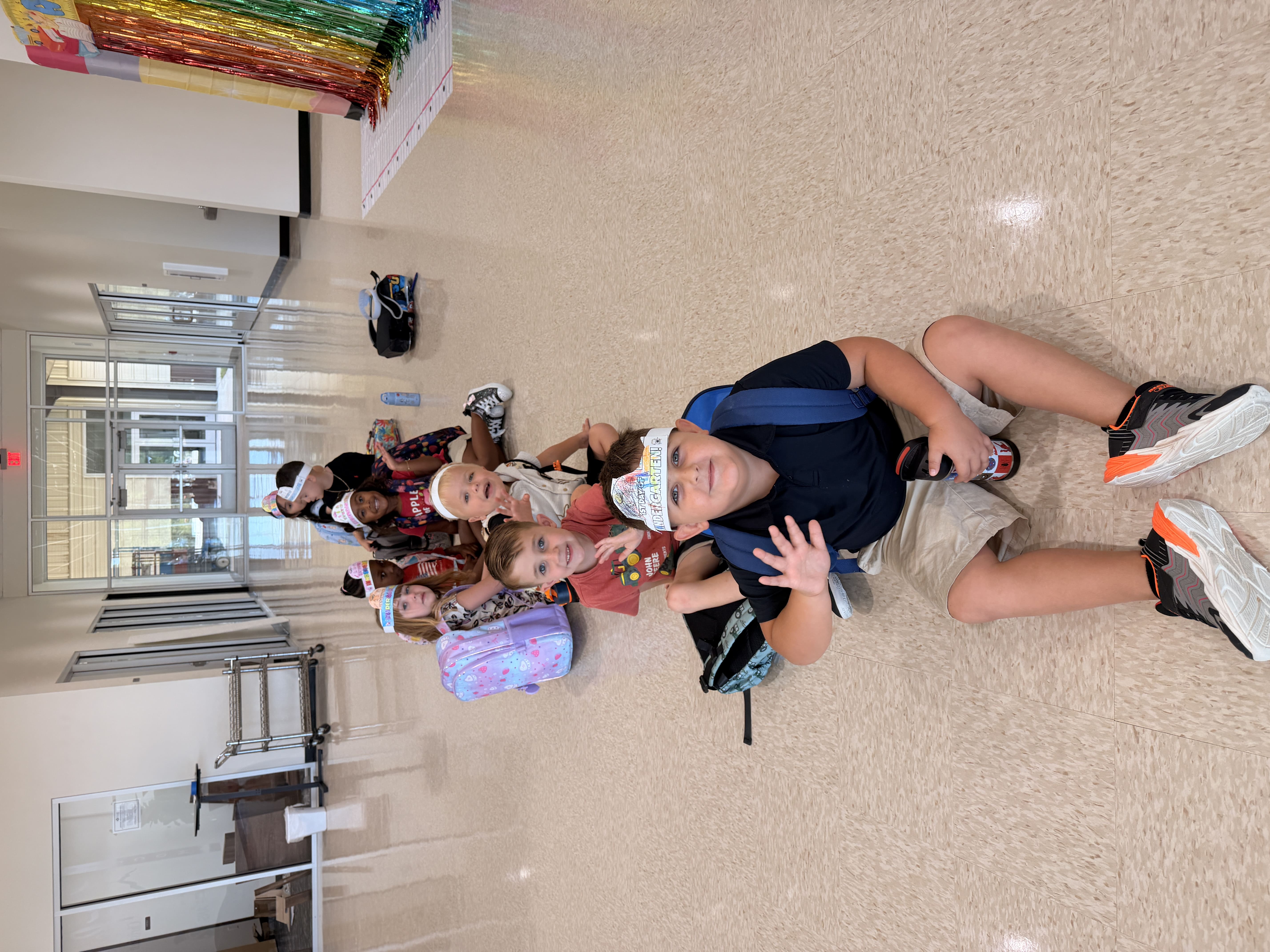 Students lined up while seating at the floor